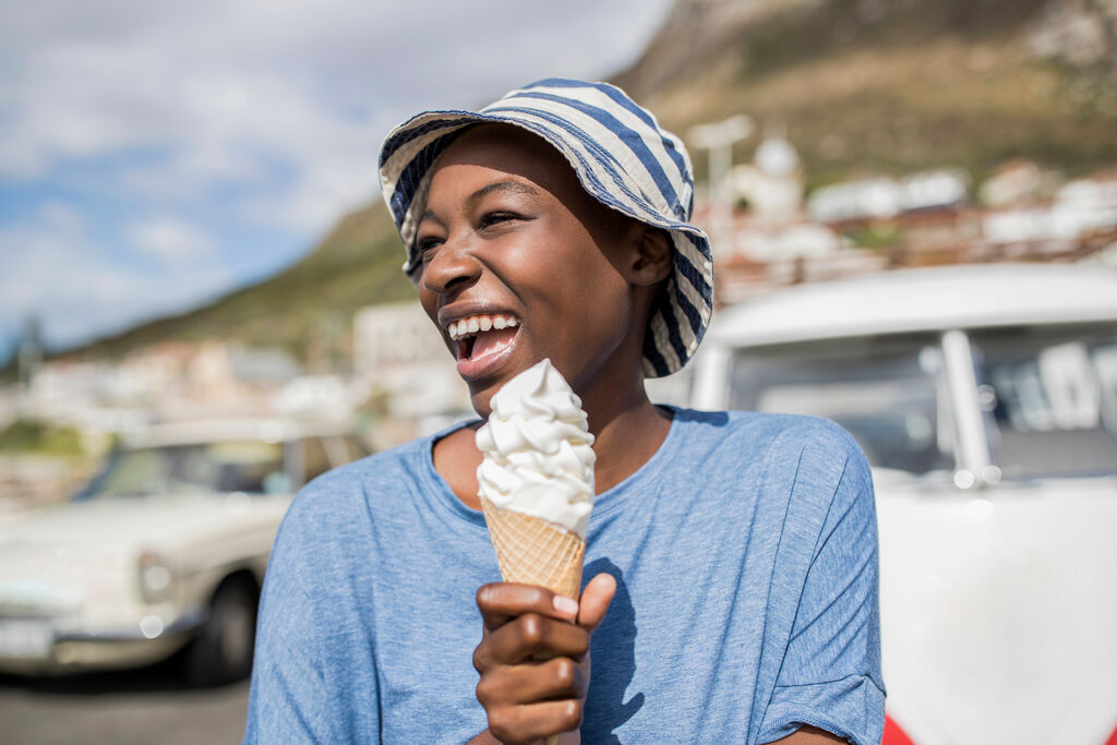 A woman enjoying an ice-cream on a sunny day