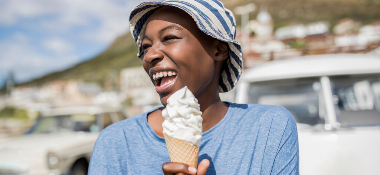 A woman enjoying an ice-cream on a nice day