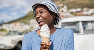 A woman enjoying an ice-cream on a sunny day