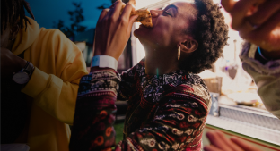 A woman eating a meal with friends A woman eating a meal with friends