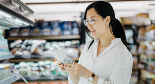 Woman looking at dairy product on supermarket