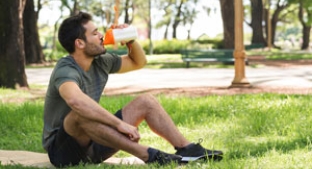 Outdoor exerciser drinking from sports bottle Outdoor exerciser drinking from sports bottle