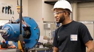 Equity, Diversity & Inclusion Black colleague operating industrial machinery